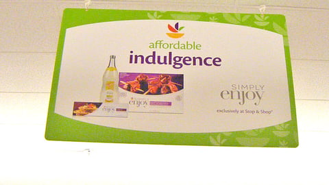 Giant 'Real Deal' Simply Enjoy Ceiling Sign